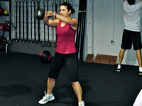 Even though workouts at Crossfit Invictus can get competitive, that doesn't stop Price from mastering kettle bell squats.